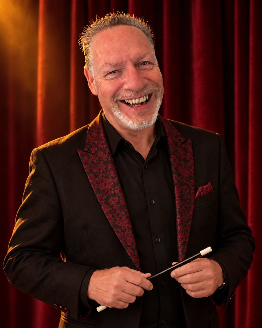 Magic AL, your friendly birthday party magician, on a warmly lit theatre stage
